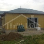 Проект дома «Ж-80» из СИП-панелей, 80 м² — одноэтажный дом с зелёной вальмовой крышей на этапе строительства | HotWell.KZ