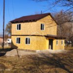 Проект дома «М-107ДД» из СИП-панелей, 107 м² — двухэтажный дом с обшивкой из плит осб и коричневой двускатной крышей | HotWell.KZ