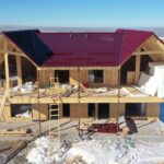 Проект дома «П-257» из СИП-панелей, 257 м² — двухэтажный дом с красной крышей и террасой на этапе строительства | HotWell.KZ