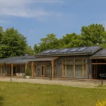Проект бани «Г-328» из СИП-панелей, 328 м² — одноэтажная баня с серым фасадом, черной крышей и панорамными окнами | HotWell.KZ