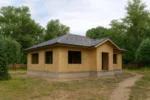 Баня «В-105», 105 м², 1 этаж, в черновой отделке: коробка из СИП-панелей OSB-3, вальмовая кровля из металлочерепицы, проёмы без окон и дверей