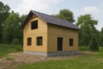 Дом «К-107В», 107 м², 1.5 этажа, в черновой отделке: коробка из СИП-панелей OSB-3, двускатная кровля из металлочерепицы, проёмы без окон и дверей, в проёмах видны сосновые балки перекрытия