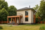 Проект дома «К-206» из СИП-панелей, 206 м² — двухэтажный дом с бежевым фасадом, серой крышей и террасой | HotWell.KZ