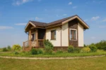 Проект дома «Н-41» из СИП-панелей, 41 м² — одноэтажный дом с бежевым фасадом, коричневой крышей и крыльцом | HotWell.KZ