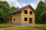 Дом «Р-170Б», 170 м², 1.5 этажа, в черновой отделке: коробка из СИП-панелей OSB-3, двускатная кровля из металлочерепицы, проёмы без окон и дверей, в проёмах видны сосновые балки перекрытия